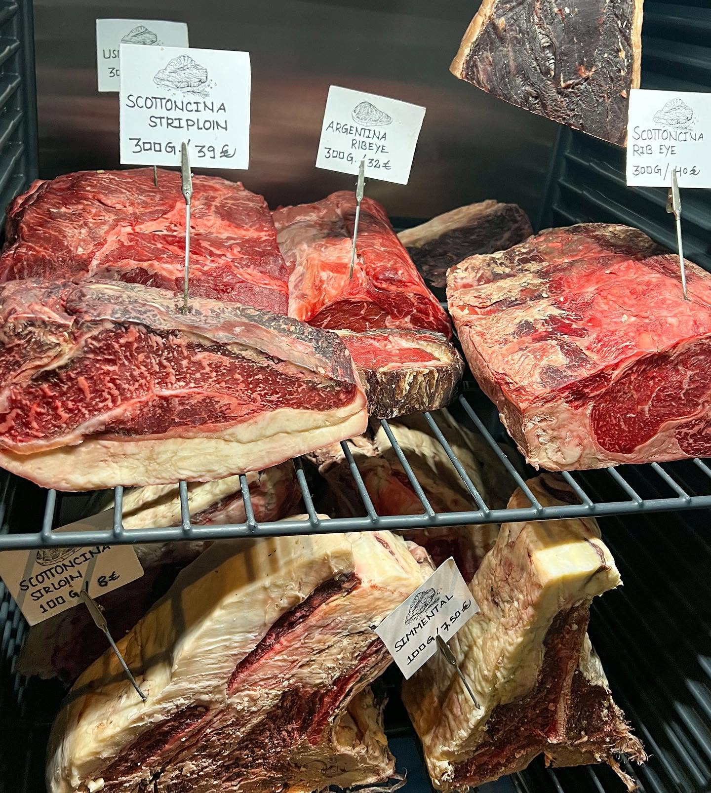 Dry-aged cuts of beef displayed at The Lucky Goose